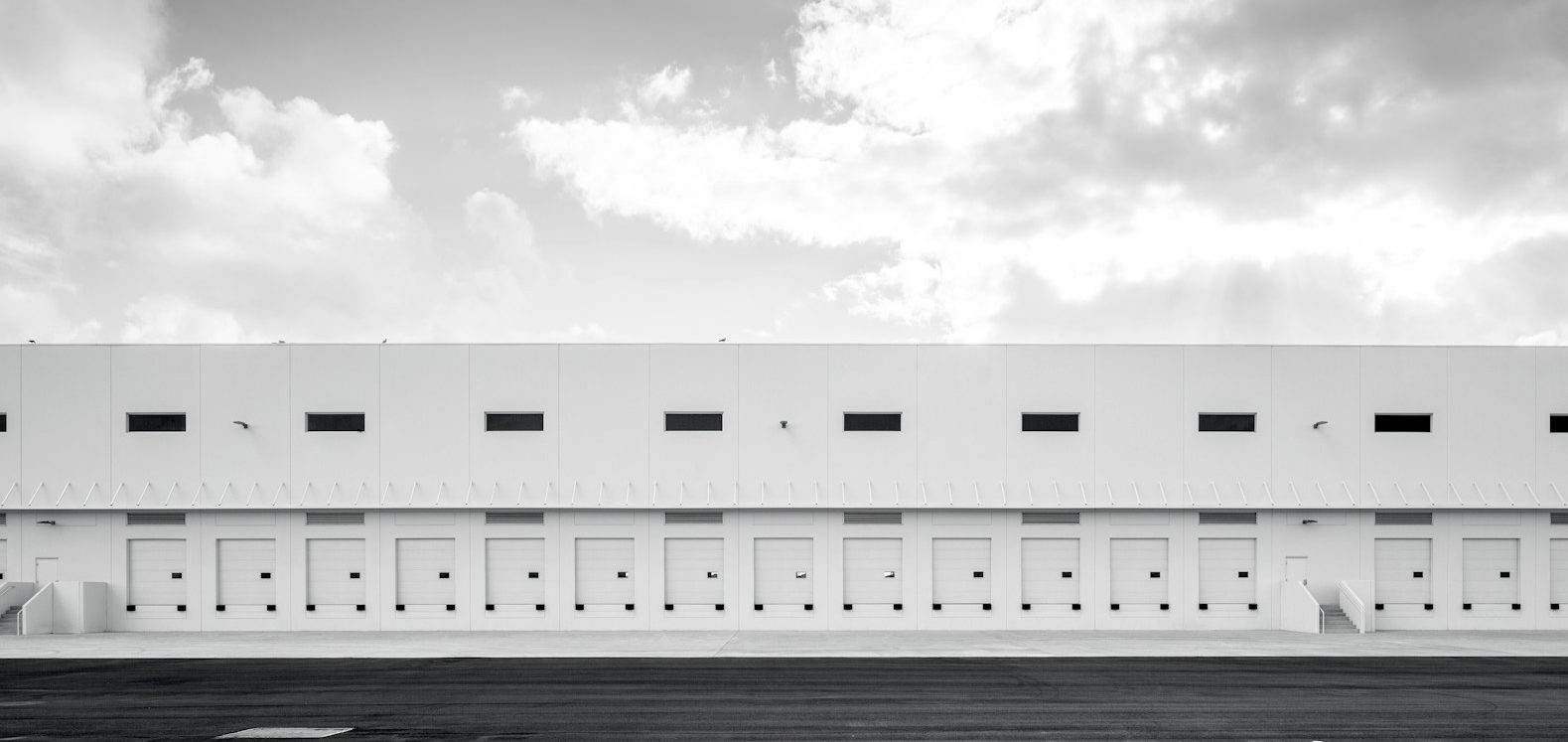 A wide angle view of the outside of a warehouse.